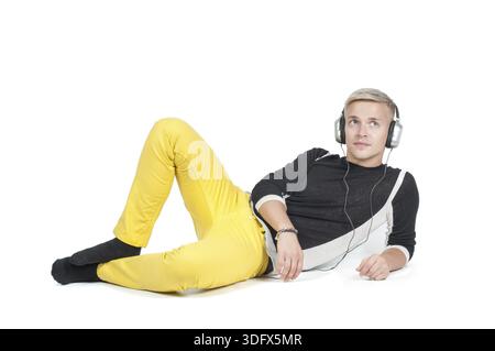 Man in headphones and yellow jeans isolated on white Stock Photo