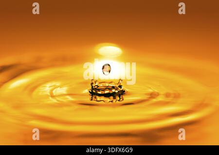 Closeup on drop of cosmetic golden oil liquid, Bunkyo district, Japan Stock Photo