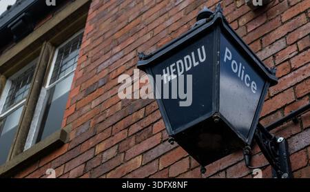 Old fashioned Welsh police lamp mounted on former police station building Stock Photo