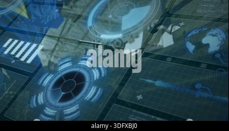 Projecting clear panels in control center, showing circular HUDs, globe, reflecting operator blazer Stock Photo