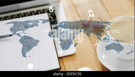 Displaying translucent world map overlay showing CO2 icons and numeric data on desk with laptop Stock Photo