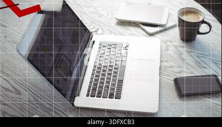 Displaying silver laptop sitting open on round wood table, with tablet, notebook, coffee mug, phone Stock Photo