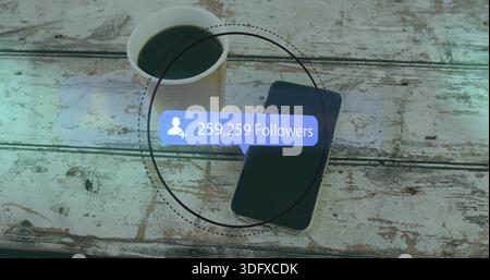 Displaying phone with screen off and coffee cup on weathered table, showing 259,259 follower bubble Stock Photo