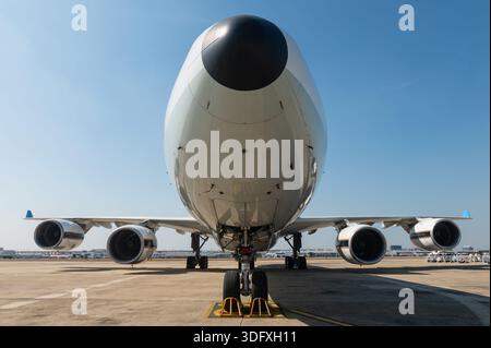 Front view of large four engine commercial airplane on airport tarmac Stock Photo