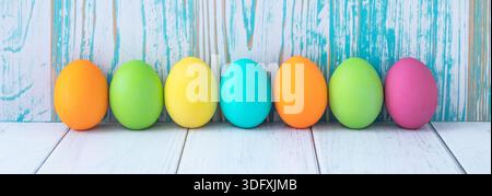 Colorful Easter eggs on blue and white wooden background. Easter card, festive background, paschal mockup, empty space. Holiday banner Stock Photo