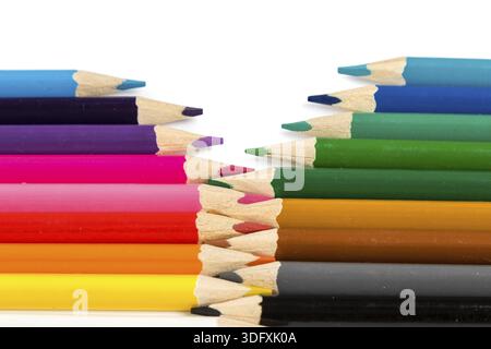 Color pencils on white table with tips in zigzag composition Stock Photo