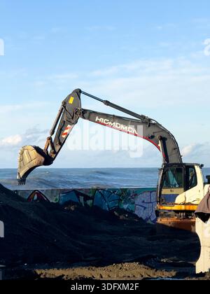 Excavator at a construction site near the sea Stock Photo - Alamy