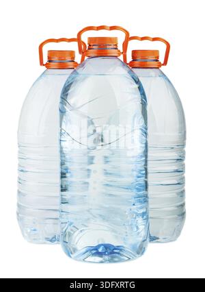 Three big full plastic water bottles with orange caps isolated on white background Stock Photo