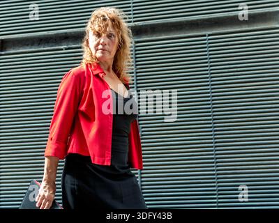 Professional woman walking with briefcase in city Stock Photo