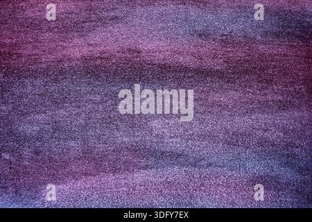 A textured, abstract background combining deep purple with indigo blue tones on a seamless canvas. The watercolor-like surface creates a dreamy, ether Stock Photo