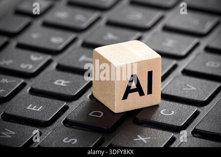 Wooden block with artificial intelligence symbol on computer keyboard Stock Photo