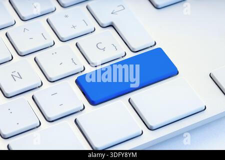 Blue blank key on white computer keyboard mockup Stock Photo