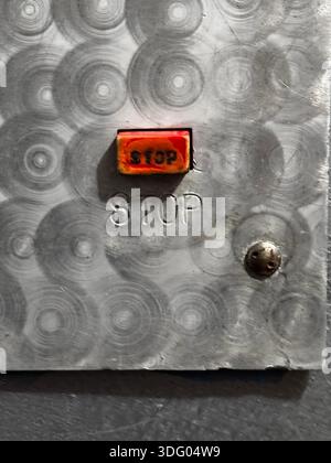 Industrial Stop Button on Metal Panel for Safety Applications Stock Photo