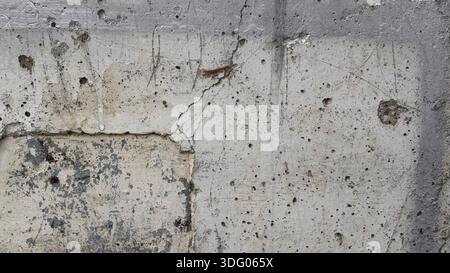 Textured Concrete Wall with Cracks and Imperfections Stock Photo