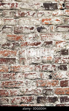 Old uneven decayed whitewashed shabby brick wall as abstract texture background Stock Photo