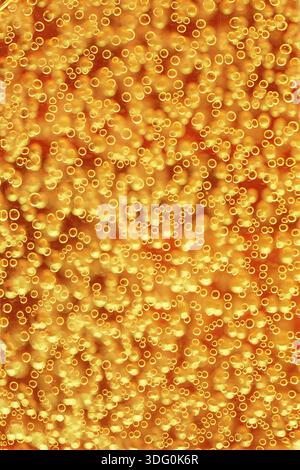 Highly detailed texture of gaseous liquid with sparkling yellow bubbles, Hiei, Japan Stock Photo