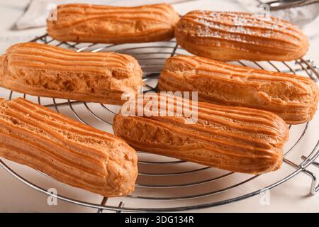 Grid with tasty eclairs on marble background Stock Photo