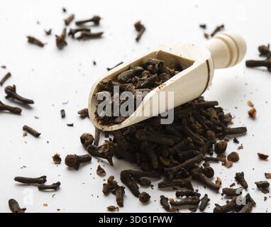 Dried cloves spice herb on white table with scoop Stock Photo