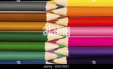 Color pencils on white table with tips in zigzag composition Stock Photo