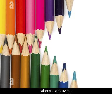 Color pencils on white table with tips in zigzag composition Stock Photo