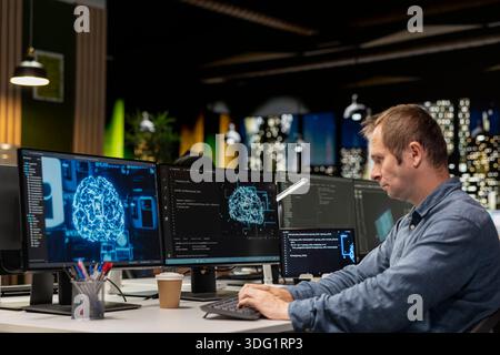 Software developer in office automating repetitive tasks using AI scripts on devices. IT professional using artificial intelligence app on computer to speed up feature implementation Stock Photo