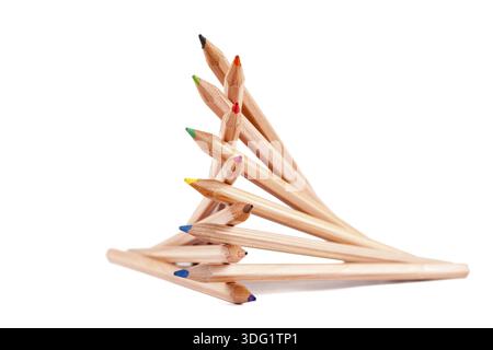 Creatively stacked pencils of different colors on white Stock Photo