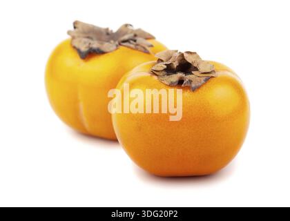Pair of ripe japanese persimmons on white background Stock Photo