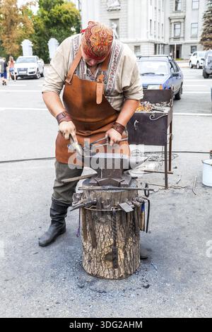 SAMARA, RUSSIA - AUGUST 29, 2015: Blacksmith handles the horseshoe on the anvil Stock Photo