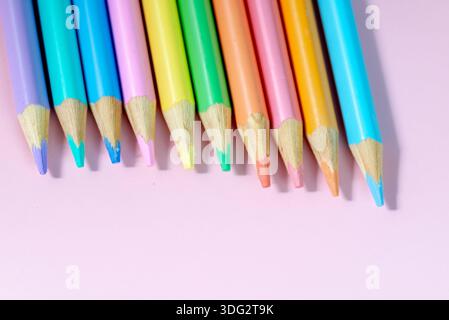 Colored pencils on a pink background Stock Photo
