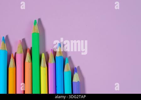 Colored pencils on a pink background Stock Photo