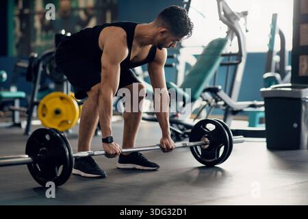 Portrait Of Muscular Middle Eastern Guy Making Deadlift Workout At Modern Gym Stock Photo