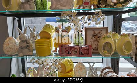 Toronto, ON, Canada - January 5, 2026: Various Easter and spring decorations stand on a glass shelf in a retail store. Stock Photo