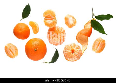 Flying sweet ripe mandarins and leaves on white background Stock Photo