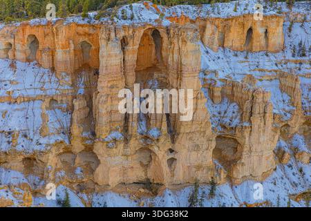Eroded sandstone wall featuring natural alcoves and snow in Bryce Canyon National Park, Utah. Stock Photo