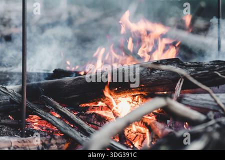 The bright small bonfire burns on riverside at evening Stock Photo