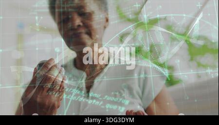 Examining senior woman in light top and necklace holding pill bottle, with DNA overlay Stock Photo