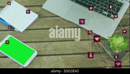 Showing green-screen phone lying lower-left on wood desk notebook laptop social-icons, copy space Stock Photo