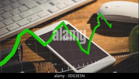 Displaying white smartphone overlapping second phone on wooden desk, with keyboard and green chart Stock Photo
