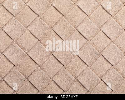 The beige texture of intertwined suede leather, forming a square abstract shape, authentic photograph, not AI-generated Stock Photo