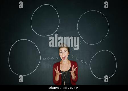 Portrait, chalkboard or woman with thought bubbles, surprise or new ideas on dark background. Expression, shocked or person with reaction, solution or Stock Photo
