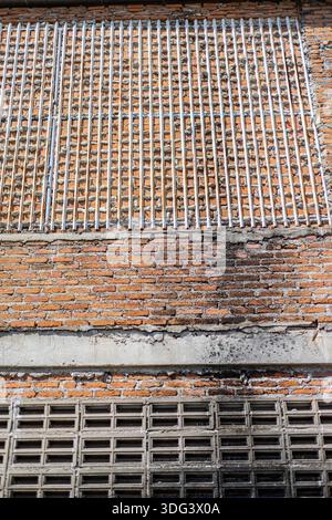 Rough Brick Texture Of Building Wall, A rugged photo of rough brick, uneven bricks with deep mortar lines and subtle weathering in daylight, for indus Stock Photo