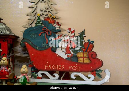 Hand painted wooden Christmas sleigh decoration featuring a snowman and gift boxes. Stock Photo