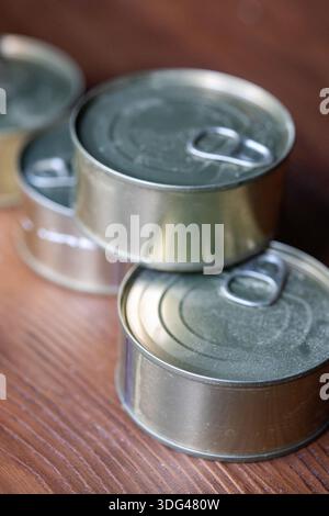 Close-up of industrial metal tin cans with pull-tabs arranged in a row Stock Photo