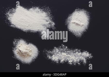 Sprinkled wheat flour splash spots on black background Stock Photo