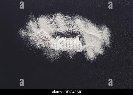Sprinkled wheat flour splash spots on black background Stock Photo