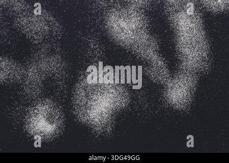 Sprinkled wheat flour splash spots on black background Stock Photo