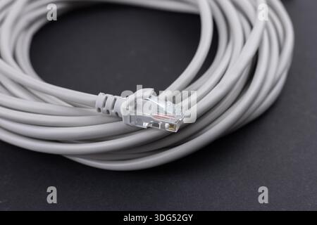 network cable, isolated on white background. Closeup LAN cables with connector. Lan cable for internet network connection, gray lan cable on a white b Stock Photo