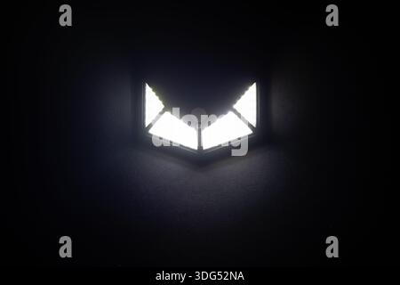 Small solar powered led light with motion sensor on dark background. Stock Photo