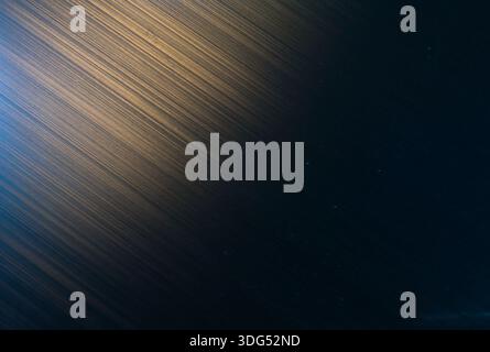 Abstract Brushed Metal Surface with Blue and Gold Light Gradient Stock Photo