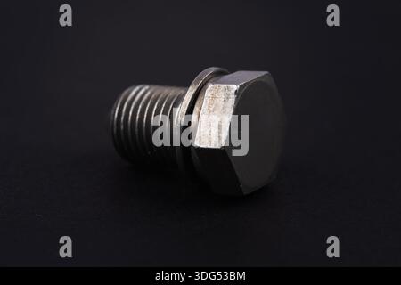 Metal bolt on dark background close up. Detail for design. Design elements. Macro. Stock Photo